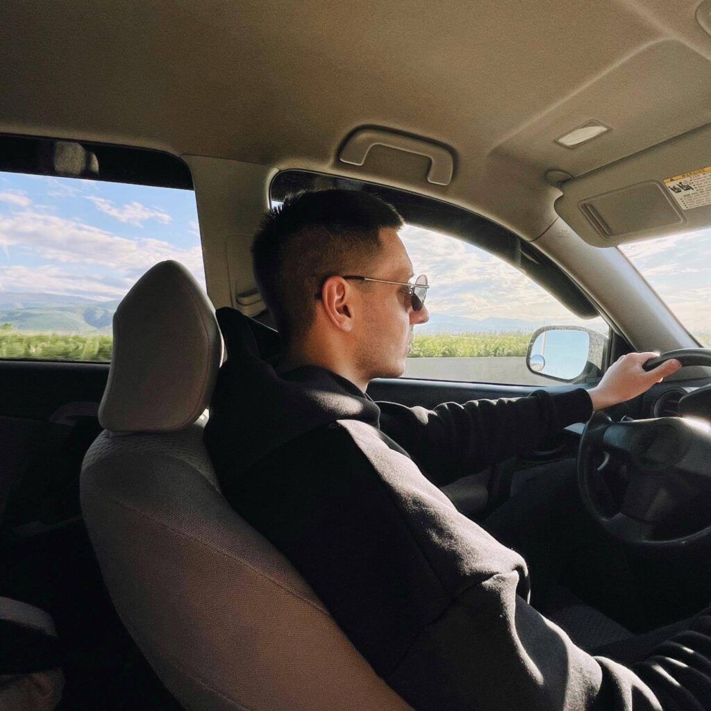 a man driving and riding in car experience of driv f34w3xb